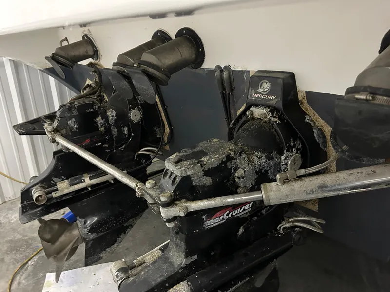 Slide: The Image of 2002 Fountain 38 Express Cruiser Mercury outdrives with visible wear and corrosion. - 11