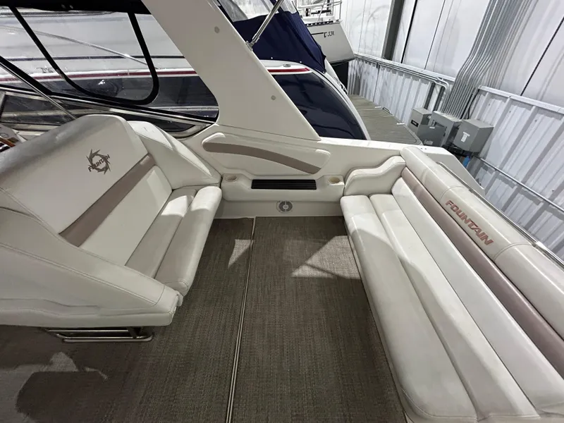 Slide: The Image of Interior seating of 2002 Fountain 38 Express Cruiser with white upholstery. - 13
