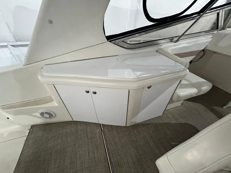 Slide: The Image of Interior view of 2002 Fountain 38 Express Cruiser with white cabinetry and seating. - 18