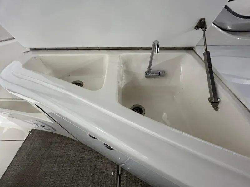 Slide: The Image of 2002 Fountain 38 Express Cruiser sink area with dual basins and faucet. - 19
