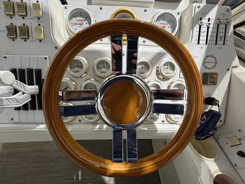 Slide: The Image of Steering wheel and dashboard of 2002 Fountain 38 Express Cruiser boat. - 29