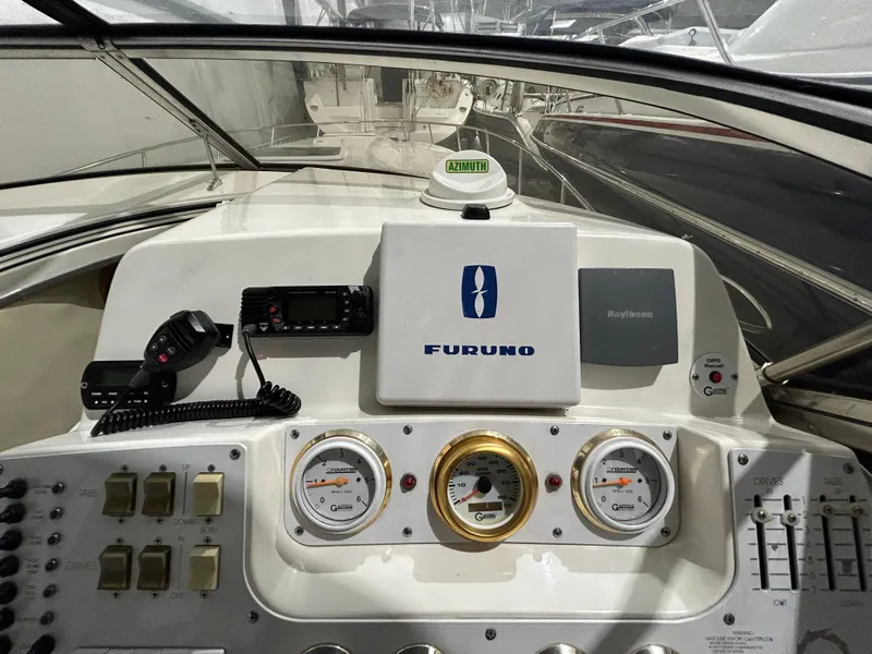 Slide: The Image of 2002 Fountain 38 Express Cruiser dashboard with navigation and communication equipment. - 30