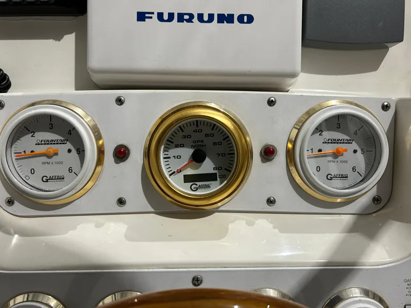 Slide: The Image of Dashboard of a 2002 Fountain 38 Express Cruiser with Furuno equipment and gauges. - 31
