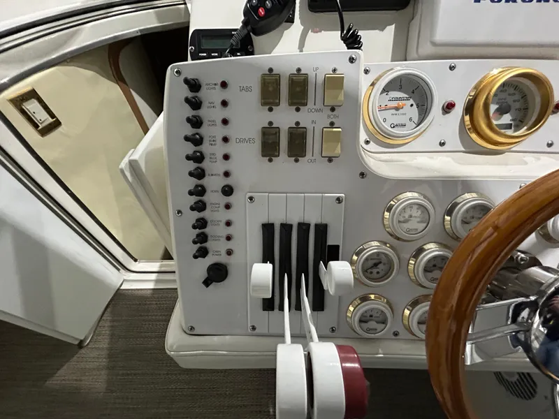 Slide: The Image of Control panel of a 2002 Fountain 38 Express Cruiser with gauges and switches. - 32
