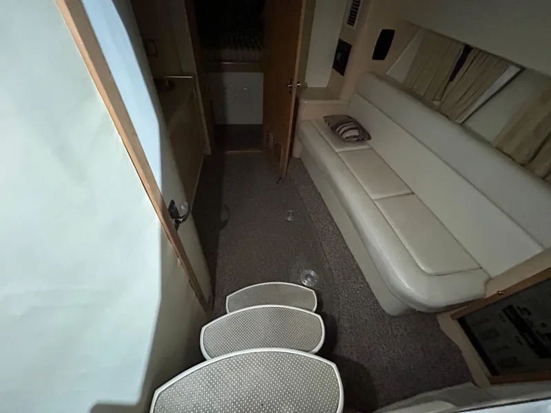 Slide: The Image of Interior of 2002 Fountain 38 Express Cruiser with white seating and carpeted steps. - 37