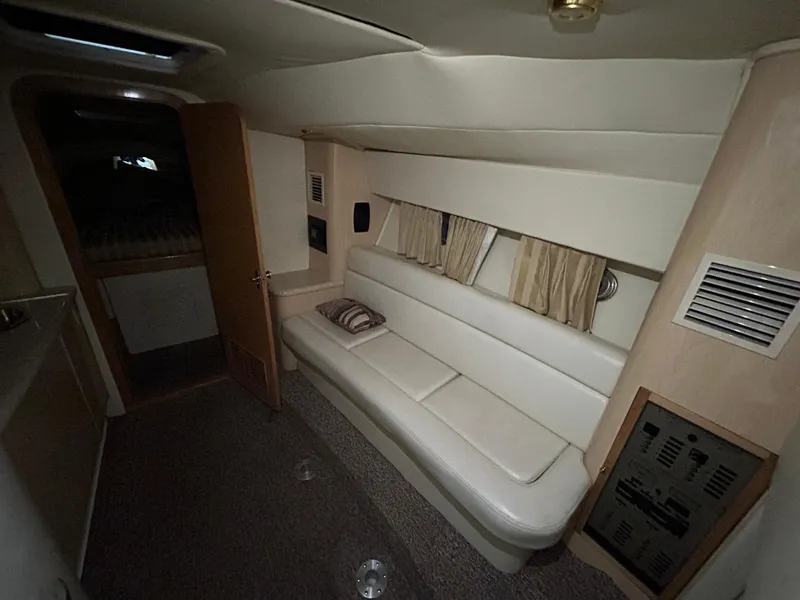 Slide: The Image of Interior of 2002 Fountain 38 Express Cruiser with white seating and beige decor. - 38