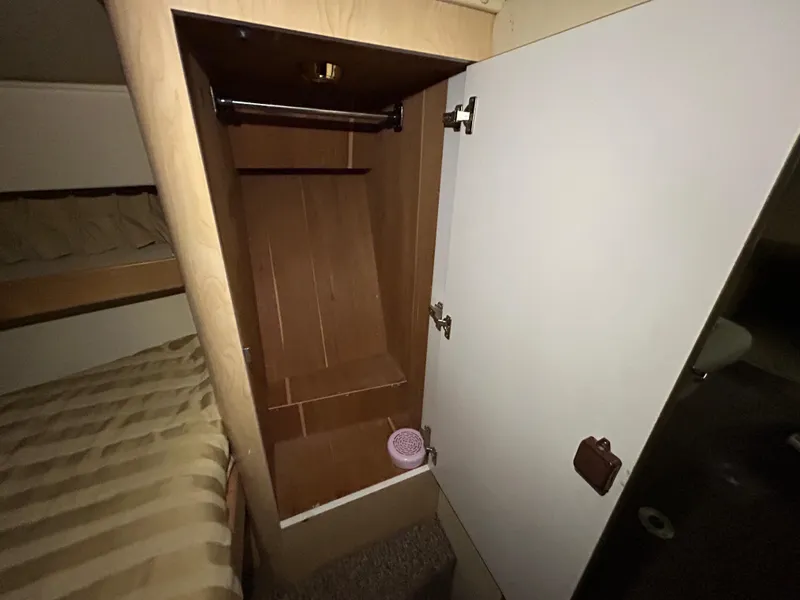 Slide: The Image of 2002 Fountain 38 Express Cruiser cabin closet interior with open door. - 45