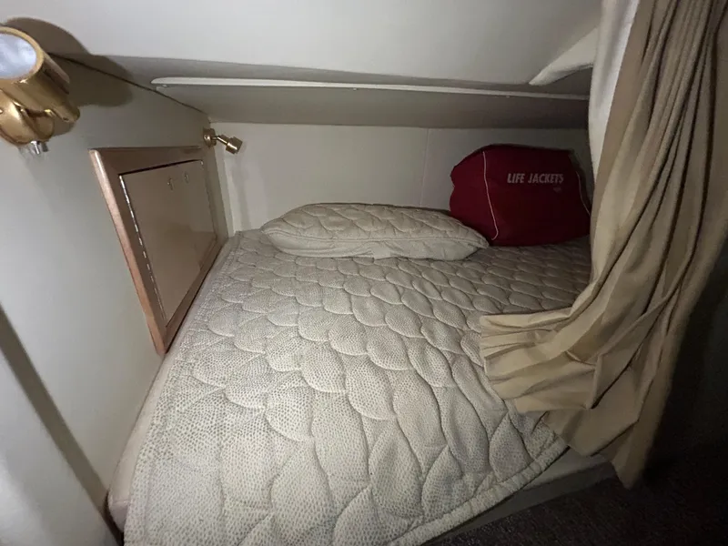 Slide: The Image of Cozy cabin bed in 2002 Fountain 38 Express Cruiser with life jackets. - 48