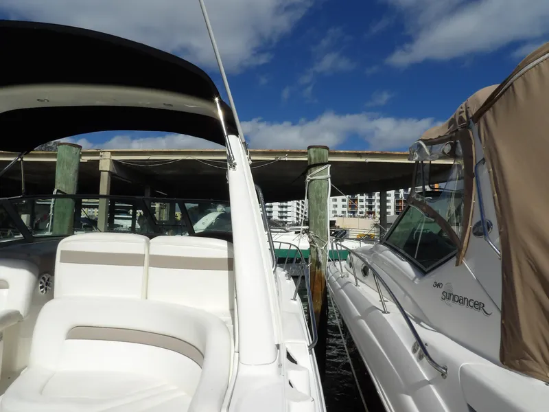 Slide: The Image of 2004 Sea Ray 320 Sundancer docked under blue sky. - 10