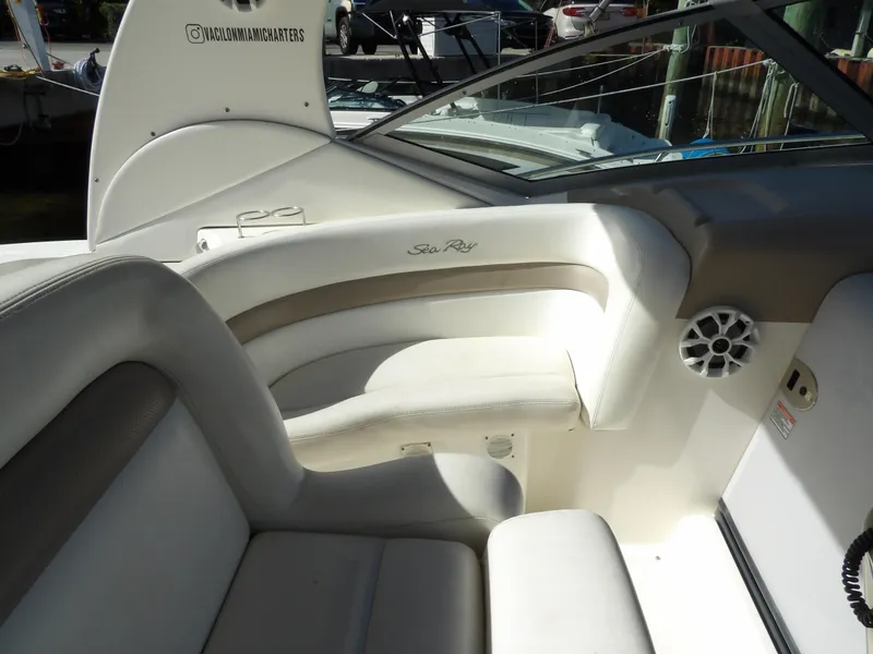 Slide: The Image of Interior of 2004 Sea Ray 320 Sundancer boat with white seating and speaker. - 14