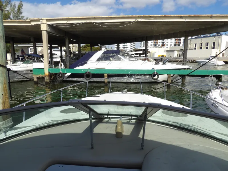 Slide: The Image of 2004 Sea Ray 320 Sundancer docked at marina with other boats. - 17