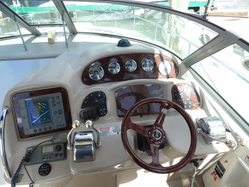 Slide: The Image of 2004 Sea Ray 320 Sundancer helm with navigation controls and gauges. - 18