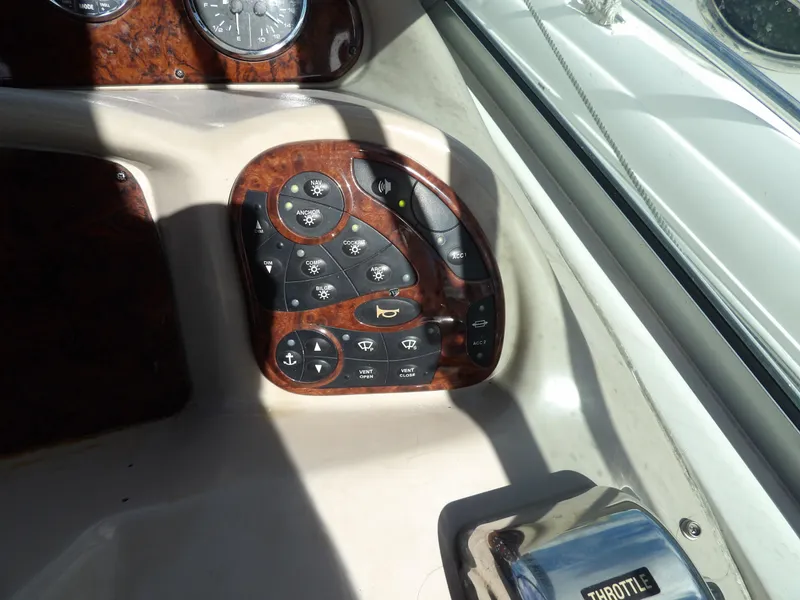 Slide: The Image of Control panel of 2004 Sea Ray 320 Sundancer boat with various switches and throttle. - 21