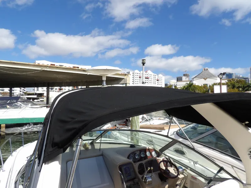 Slide: The Image of 2004 Sea Ray 320 Sundancer docked under blue sky. - 25