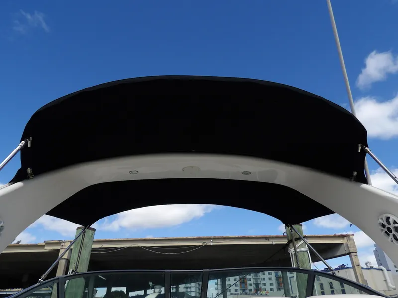 Slide: The Image of 2004 Sea Ray 320 Sundancer boat canopy against a clear blue sky. - 26