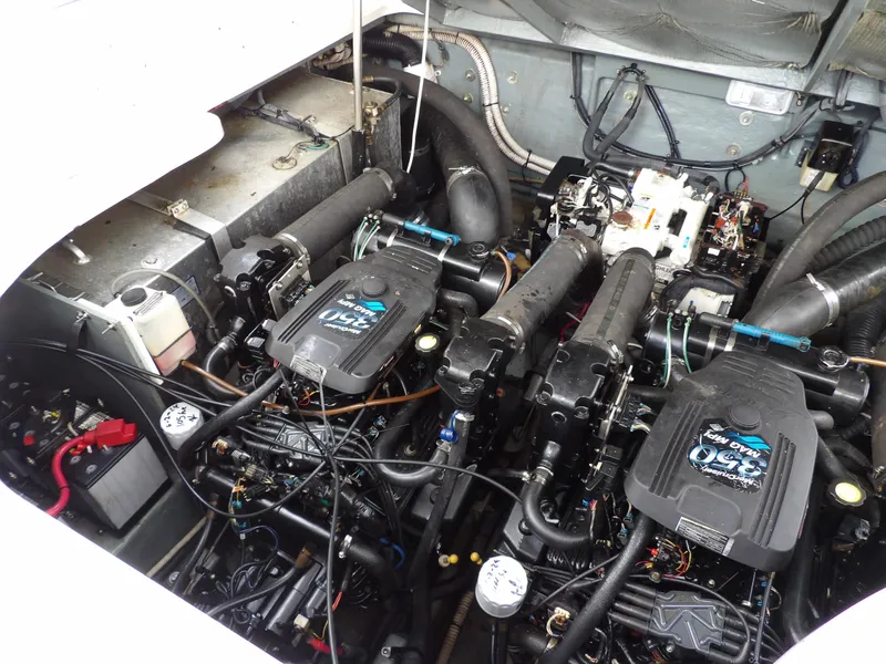 Slide: The Image of Engine compartment of 2004 Sea Ray 320 Sundancer with dual engines and wiring. - 28