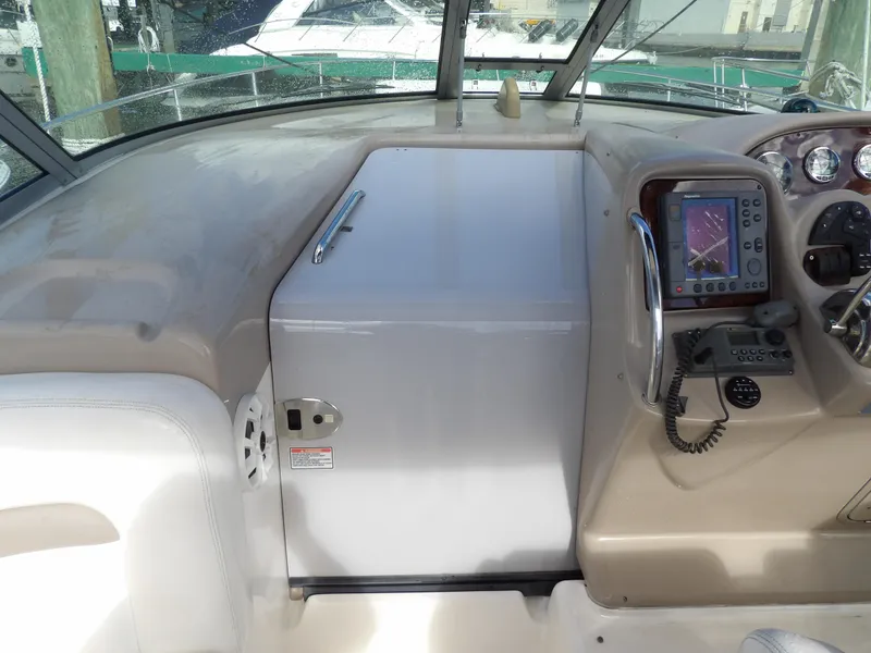 Slide: The Image of 2004 Sea Ray 320 Sundancer helm with navigation equipment and controls. - 32