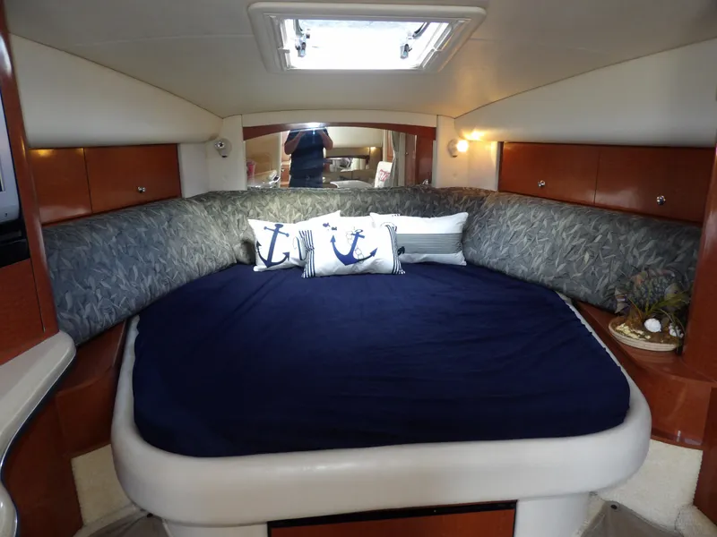 Slide: The Image of Luxurious cabin interior of 2004 Sea Ray 320 Sundancer with cozy bedding and nautical decor. - 42