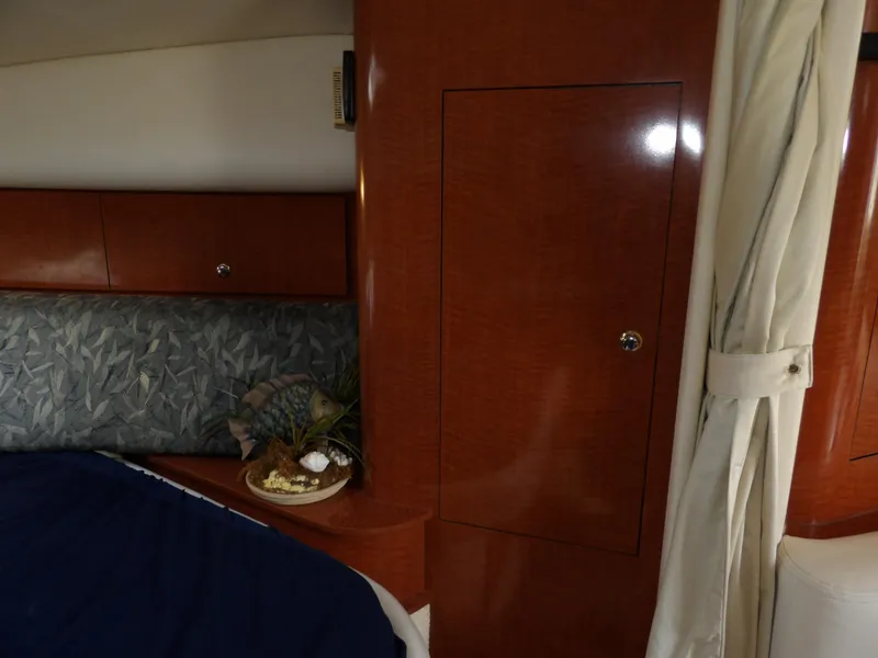 Slide: The Image of Interior cabin of 2004 Sea Ray 320 Sundancer with wood paneling and decorative accents. - 43
