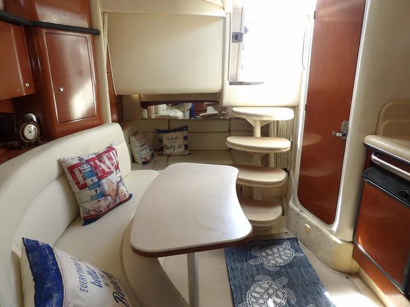Slide: The Image of Interior of 2004 Sea Ray 320 Sundancer with cozy seating and elegant wooden finishes. - 46