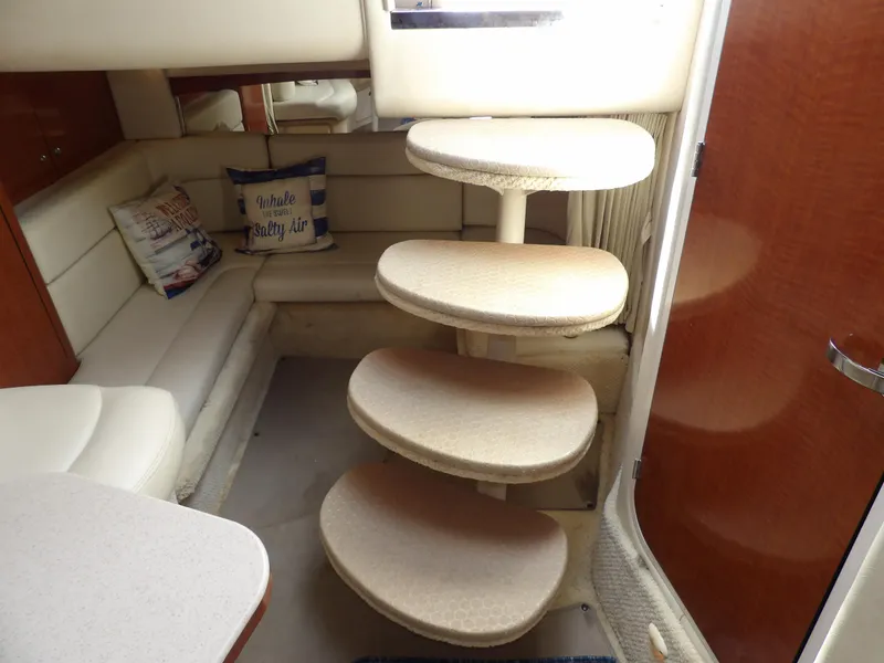 Slide: The Image of Interior of 2004 Sea Ray 320 Sundancer with curved steps and cozy seating area. - 47