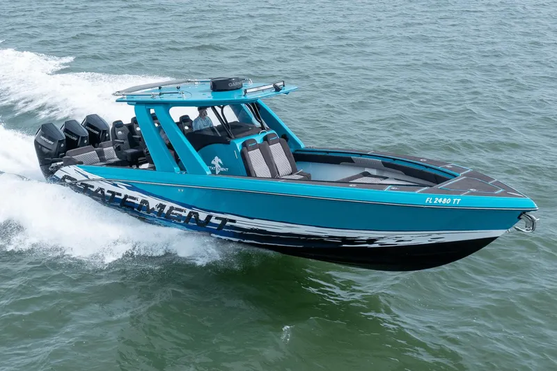 Slide: The Image of 2024 Statement 38 Open boat cruising on water, featuring vibrant blue design and multiple engines. - 15