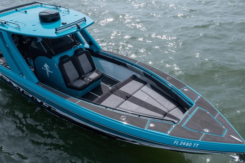 Slide: The Image of 2024 Statement 38 Open boat with sleek design on water. - 24