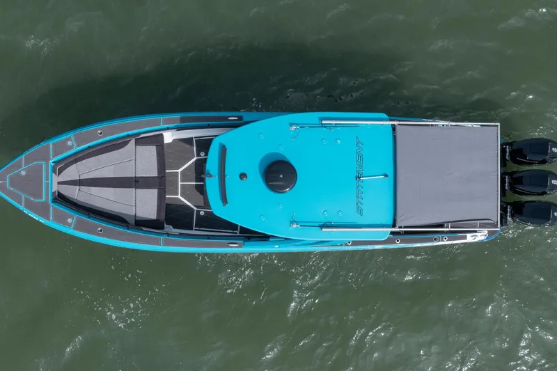 Slide: The Image of Top view of 2024 Statement 38 Open boat on water, featuring sleek design and triple engines. - 27