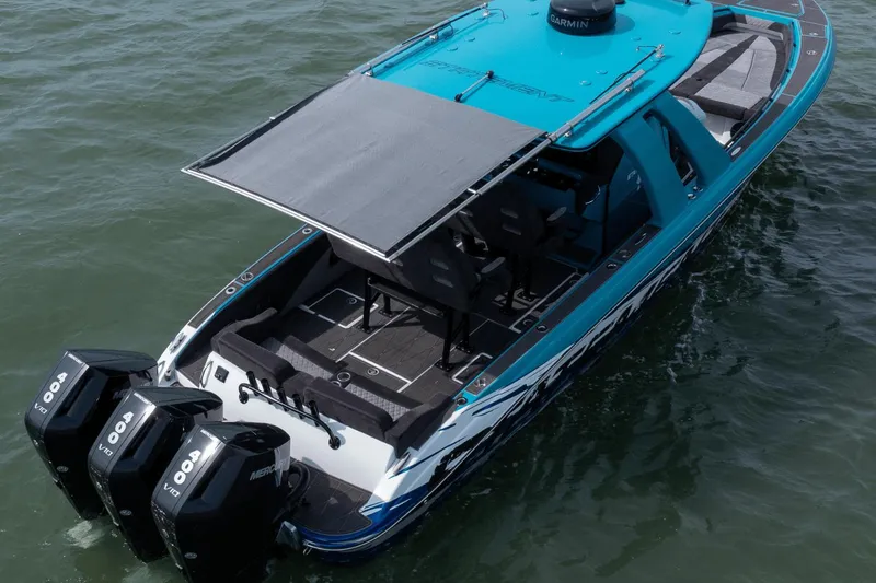 Slide: The Image of 2024 Statement 38 Open boat with triple Mercury engines on water. - 31