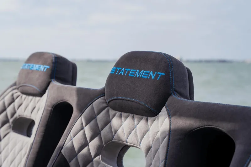 Slide: The Image of 2024 Statement 38 Open boat seats with quilted design and blue stitching by the sea. - 40