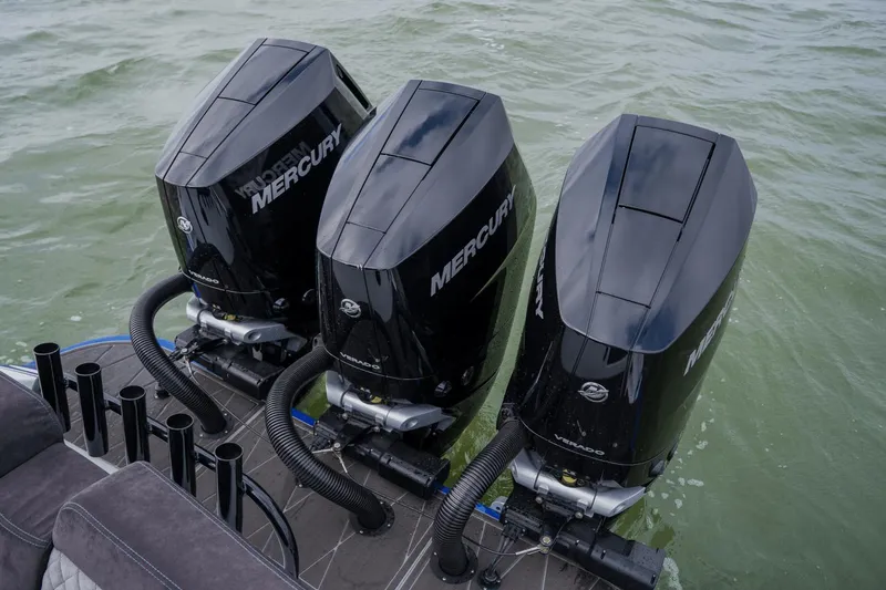 Slide: The Image of Triple Mercury outboard engines on 2024 Statement 38 Open boat in water. - 47