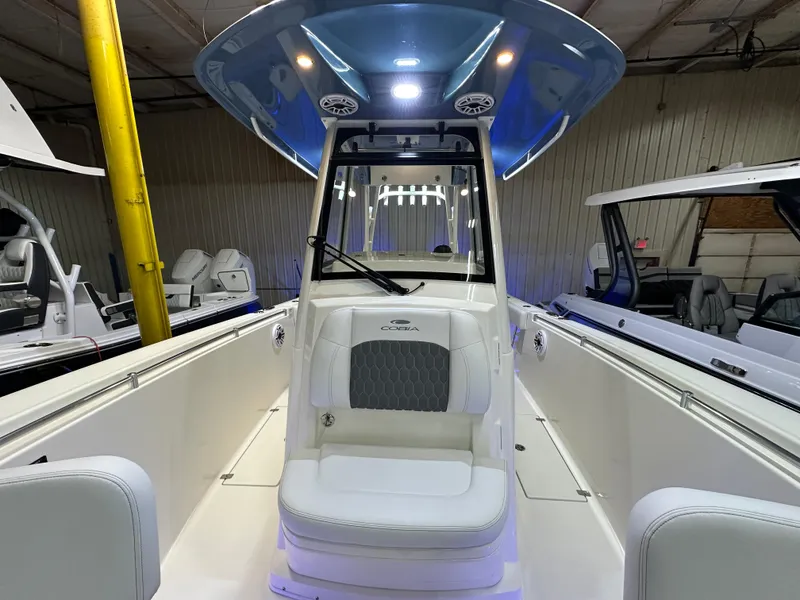 Slide: The Image of 2025 Cobia 301 Center Console boat interior with blue T-top and seating. - 14