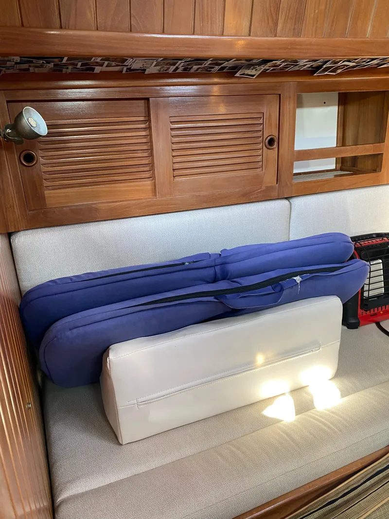 Slide: The Image of Cabo Rico 38 sailboat interior with cushions and wooden cabinetry, 1988 model. - 10