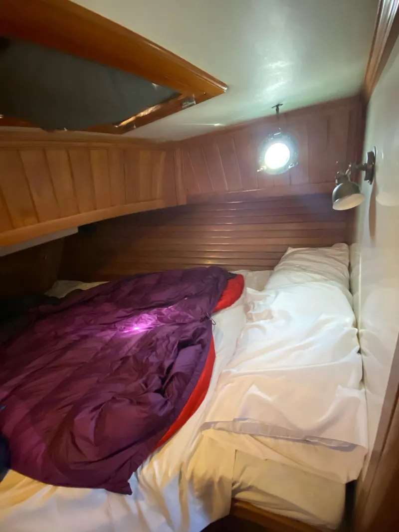 Slide: The Image of Cozy cabin interior of 1988 Cabo Rico 38 sailboat with bed and porthole. - 13