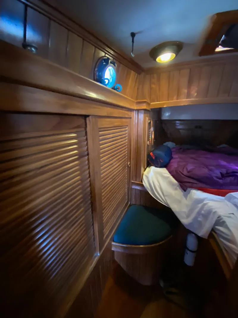 Slide: The Image of Cozy cabin interior of 1988 Cabo Rico 38 sailboat with wooden paneling and bed. - 14