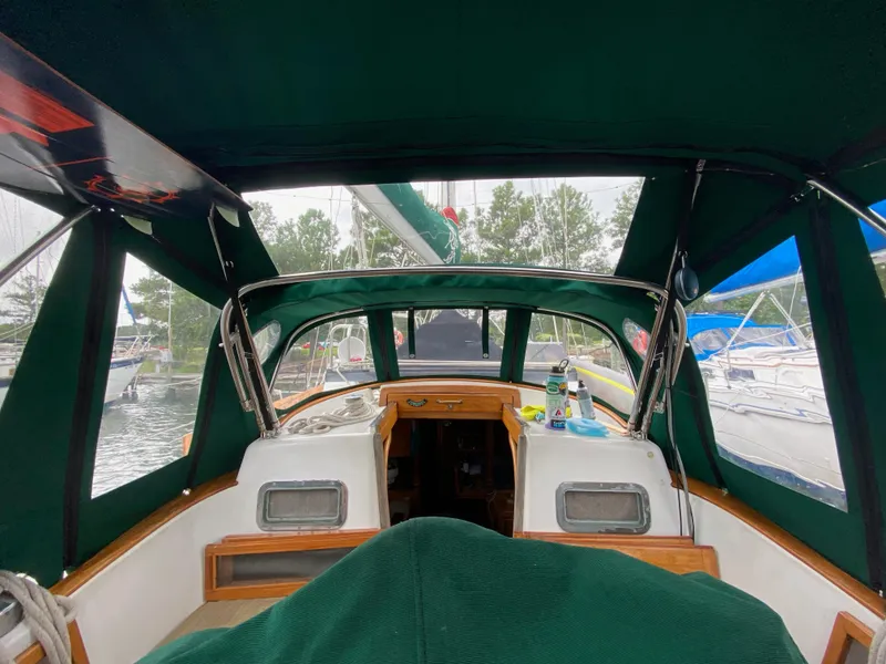 Slide: The Image of Interior view of 1988 Cabo Rico 38 sailboat with green canopy and wooden accents. - 3