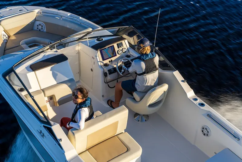 Slide: The Image of 2024 Boston Whaler 210 Vantage boat on water, featuring modern cockpit and seating. - 13