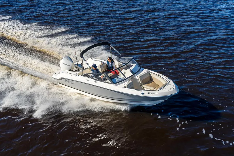 Slide: The Image of 2024 Boston Whaler 210 Vantage cruising on open water, showcasing sleek design and performance. - 14