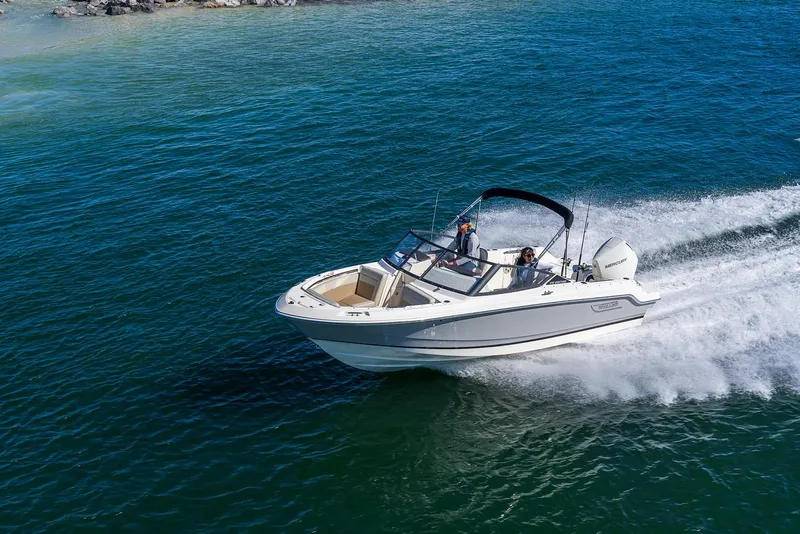 Slide: The Image of 2024 Boston Whaler 210 Vantage cruising on open water. - 16