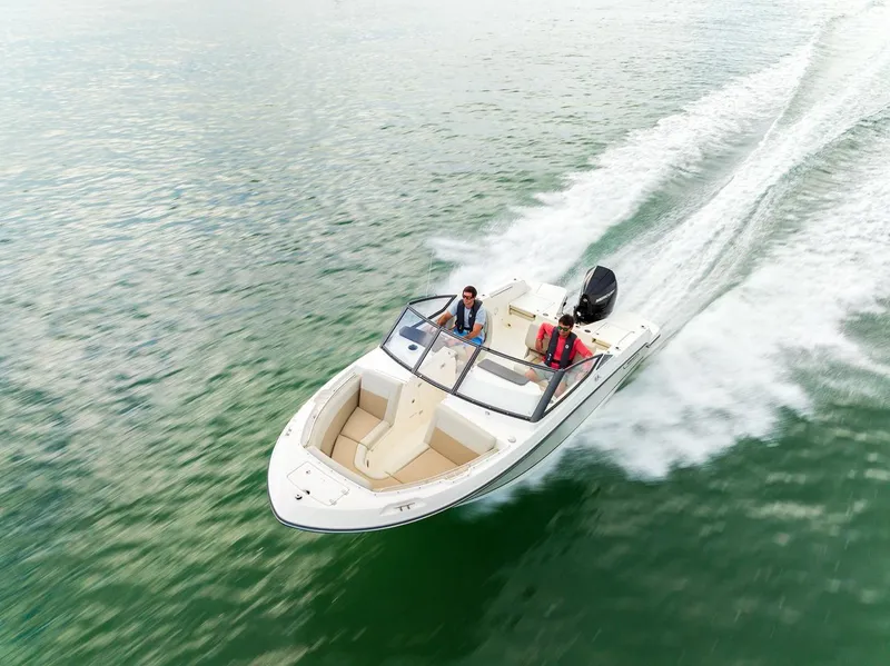 Slide: The Image of 2024 Boston Whaler 210 Vantage cruising on open water. - 20