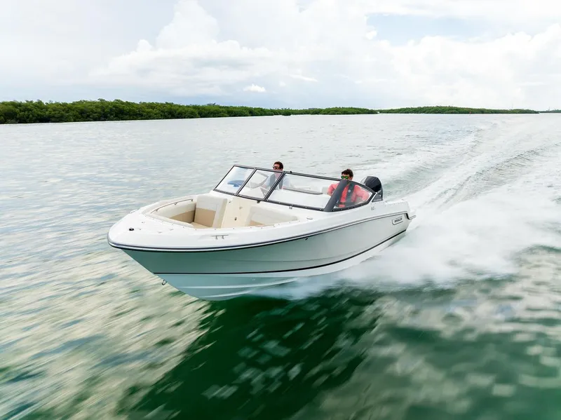 Slide: The Image of 2024 Boston Whaler 210 Vantage cruising on open water. - 21