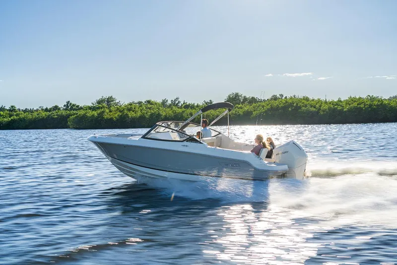 Slide: The Image of 2024 Boston Whaler 210 Vantage cruising on a sunny lake. - 27