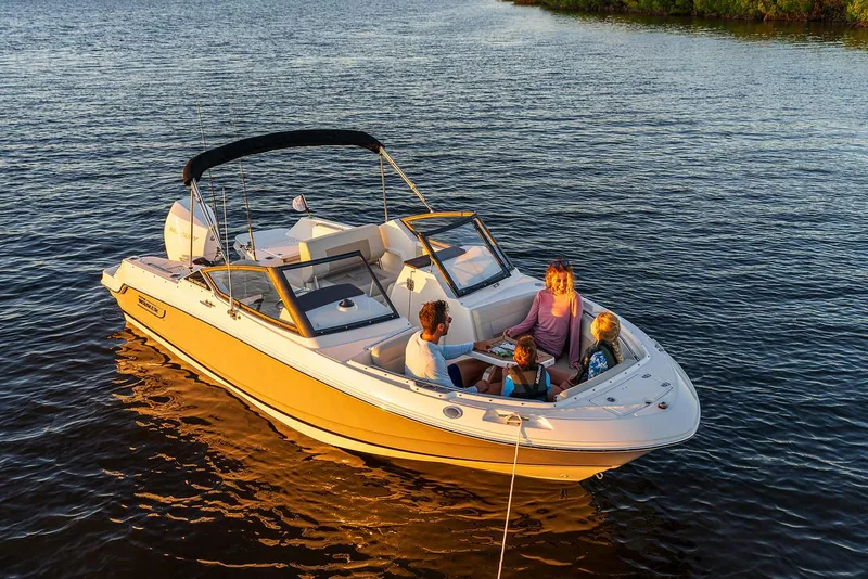 Slide: The Image of 2024 Boston Whaler 210 Vantage boat with family enjoying a sunny day on the water. - 4