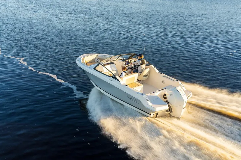 Slide: The Image of 2024 Boston Whaler 210 Vantage cruising on open water. - 8
