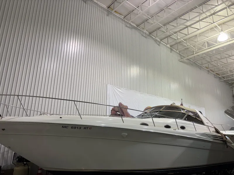 The Image of 1999 Sea Ray 450 Sundancer yacht in indoor storage facility. - 0
