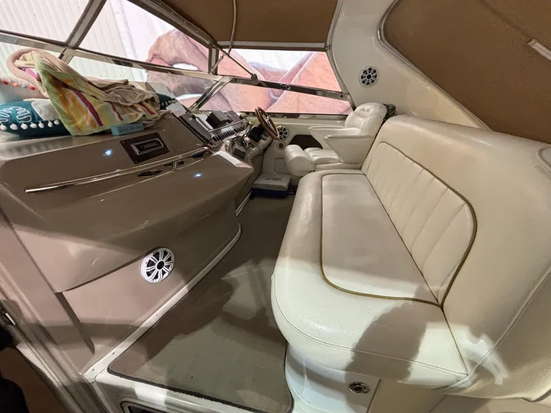 Slide: The Image of Interior of 1999 Sea Ray Sundancer 450 with plush seating and table. - 14