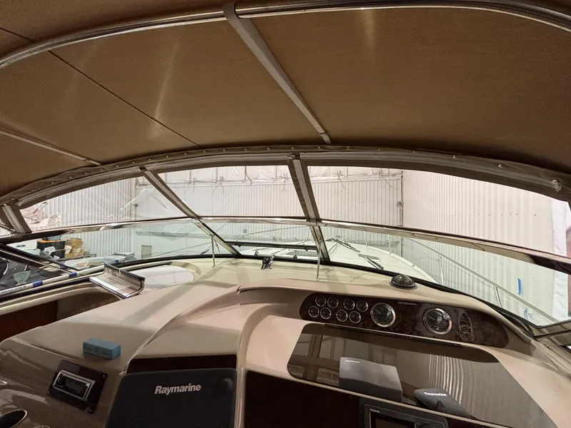 Slide: The Image of Interior of 1999 Sea Ray Sundancer 450 showing storage cabinets and seating area. - 16