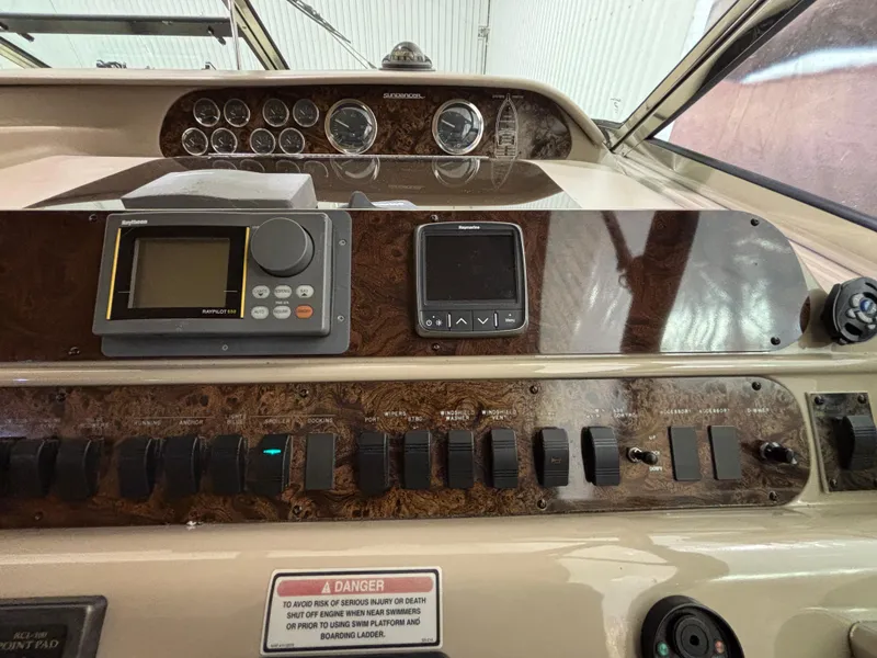 Slide: The Image of 1999 Sea Ray Sundancer 450 interior with beige seating and helm controls. - 17