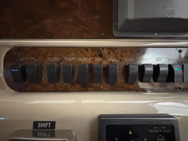 Slide: The Image of 1999 Sea Ray Sundancer 450 helm with wooden steering wheel and navigation controls. - 18