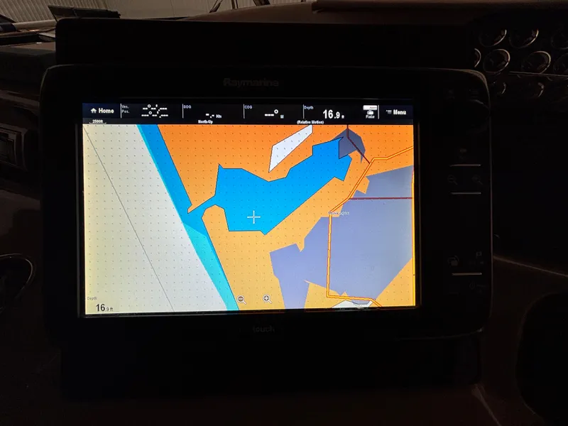 Slide: The Image of 1999 Sea Ray Sundancer 450 helm with Raymarine navigation system in a covered dock. - 19